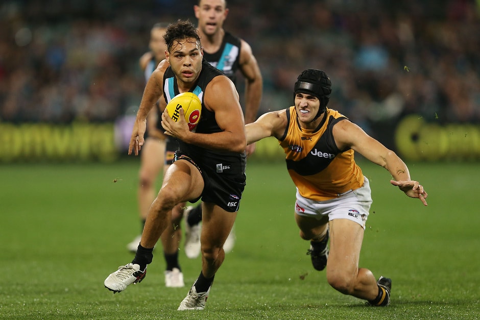 AFL 2016 Rd 15 - Port Adelaide v Richmond ADELAIDE, AUSTRALIA - JULY 01: Jarman Impey of the Power is tackled by Ben Griffiths of the Tigers during the 2016 AFL Round 15 match between Port Adelaide Power and the Richmond Tigers at Adelaide Oval on July 1, 2016 in Adelaide, Australia. (Photo by James Elsby/AFL Media)
